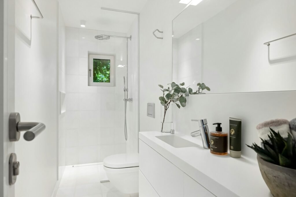 A white bathroom with a toilet and a sink